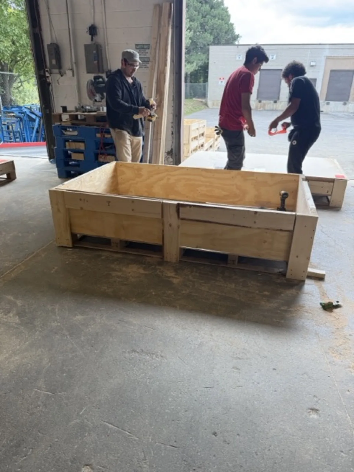 RF Transparent team members building shipping crates in a warehouse